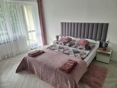 a bedroom with a bed with two pillows on it at Apartament Premium Tarnów in Tarnów