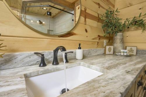 a bathroom with a sink and a mirror at NewListing! 1-Mile Choctaw Landing, GameRoom, 6BR, Sleep-18, PET Friendly, HotTub, Play Structure, Smart TV, FirePit, Outdoor in Stephens Gap