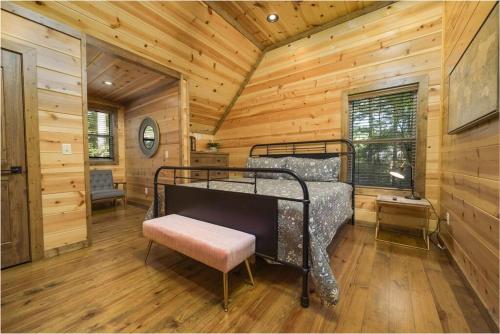 a bedroom with a bed in a log cabin at NewListing! 1-Mile Choctaw Landing, GameRoom, 6BR, Sleep-18, PET Friendly, HotTub, Play Structure, Smart TV, FirePit, Outdoor in Stephens Gap