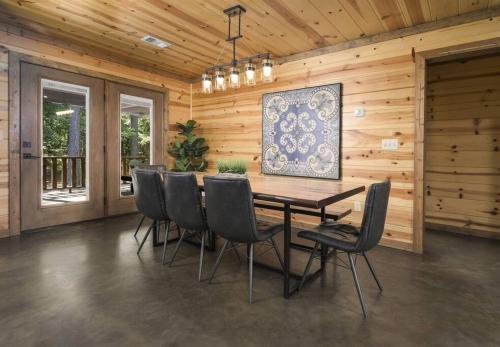 a dining room with a table and chairs at NewListing! 1-Mile Choctaw Landing, GameRoom, 6BR, Sleep-18, PET Friendly, HotTub, Play Structure, Smart TV, FirePit, Outdoor in Stephens Gap