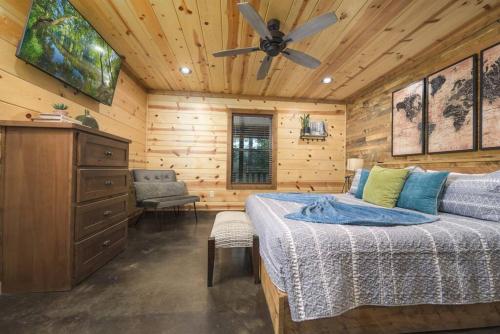 a bedroom with a bed and a ceiling fan at NewListing! 1-Mile Choctaw Landing, GameRoom, 6BR, Sleep-18, PET Friendly, HotTub, Play Structure, Smart TV, FirePit, Outdoor in Stephens Gap