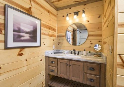 a bathroom with a sink and a mirror at NewListing! 1-Mile Choctaw Landing, GameRoom, 6BR, Sleep-18, PET Friendly, HotTub, Play Structure, Smart TV, FirePit, Outdoor in Stephens Gap