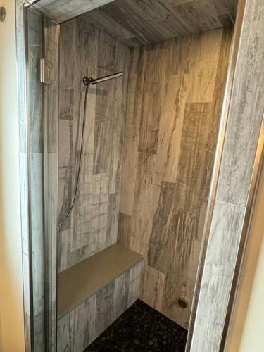 a shower with a glass door in a bathroom at Mayor's Lake and Ski Suite in Sandpoint