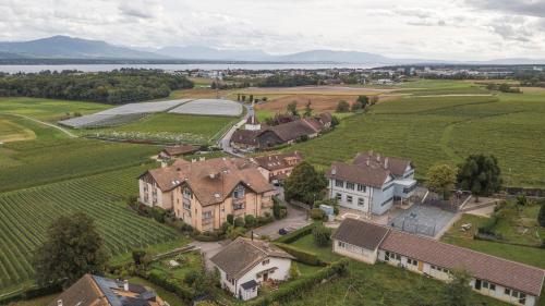 an aerial view of a large estate with a farm at Amanthos Living Nyon in Duillier