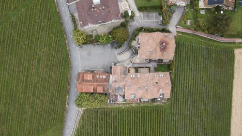 an overhead view of a house in a field at Amanthos Living Nyon in Duillier