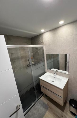 a bathroom with a sink and a shower at Cura Sea View Apartment in Playa del Cura