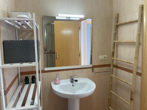 a bathroom with a sink and a mirror at Apartamento El Mirador de Sierra Mágina II Noalejo entre Granada y Jaén in Noalejo