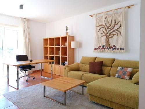 a living room with a couch and a table at Villa Martin in Óbidos