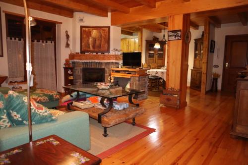 a living room with a couch and a fireplace at ERA CASETA de Salardu in Salardú