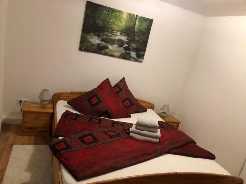 a bedroom with two beds with red pillows at Ferienwohnung 2Doppel 1 Einzel Bett in Siegen