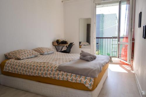 a bedroom with a bed with a stuffed animal on it at Daz house in Sevran