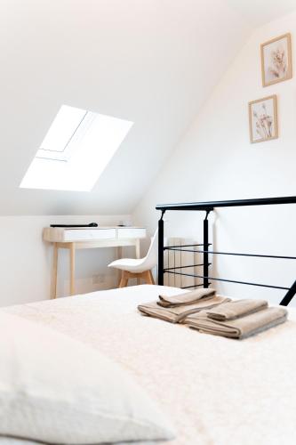 a white bedroom with a bed and a desk at Maison Cosy Centre Gare Amiens in Amiens