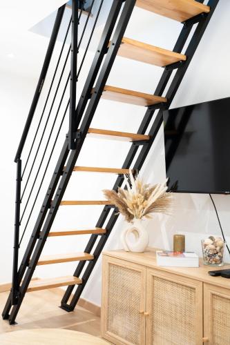 a black and wooden staircase in a living room at Maison Cosy Centre Gare Amiens in Amiens