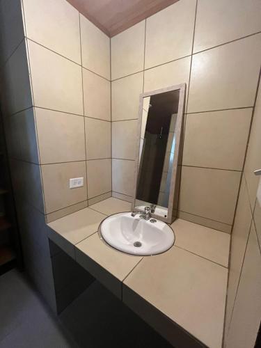 a bathroom with a sink and a mirror at Spanish by the Sea - Bocas in Bocas Town