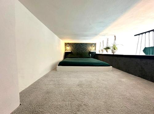 a bedroom with a green bed in a white room at Green Garden Děčín in Děčín