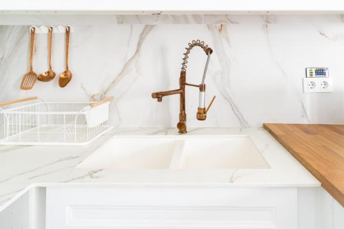 a kitchen counter with a sink and a faucet at Spiral Stairs Duplex in Figueres
