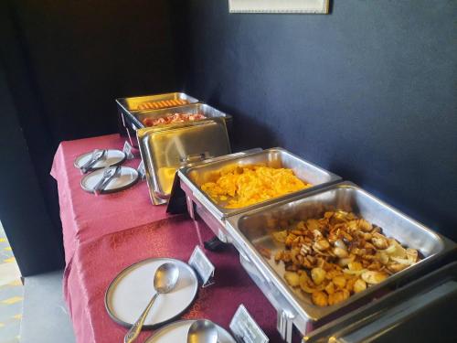a table with two trays of food on it at The Bridge Residence Hotel in Kanchanaburi