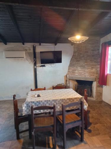 a dining room with a table and chairs and a fireplace at Mozitas 33 in Barra del Chuy
