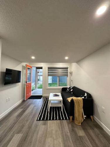 a living room with a couch and a table at The Urban Nest in Calgary