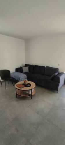 a living room with a black couch and a coffee table at Nowa Osada in Łącko