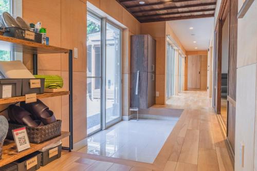 a hallway of a home with glass doors at Guesthouse TOMARITOMARO in Shikineshima