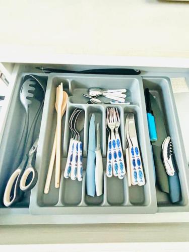 a plastic container filled with utensils in a drawer at Maison Jula Confort, Relax e Libertà, Cinquale in Cinquale