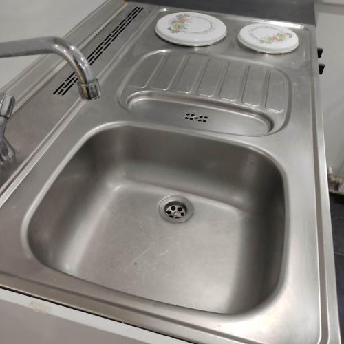 a kitchen sink with two plates on top of it at Modernes einzimmer Apartment in Hügelsheim