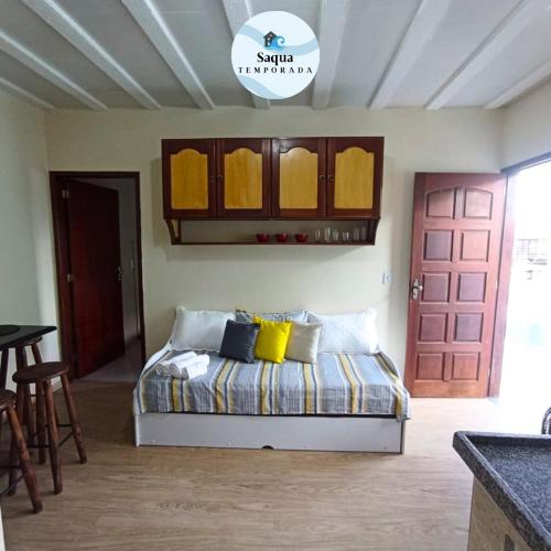 a bedroom with a bed with yellow pillows on it at LAGOA I - Saquarema RJ in Saquarema