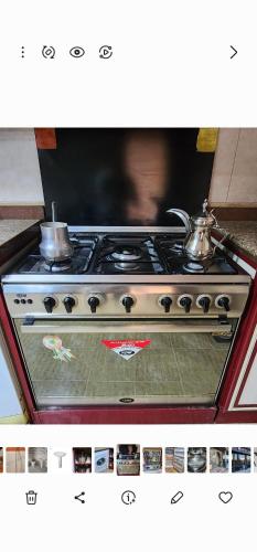 a stove with two tea pots on top of it at Apartment in front of Mansoura University 5 stars in Mansoura