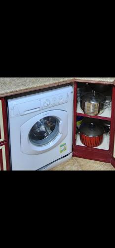 a small kitchen with a stove and a dishwasher at Apartment in front of Mansoura University 5 stars in Mansoura