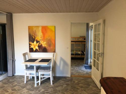 a dining room with a table and a painting on the wall at Zoo apartment tæt på Legoland, Lego-house, lalandia in Grindsted