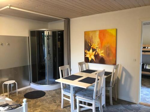 a dining room with a table and a painting on the wall at Zoo apartment tæt på Legoland, Lego-house, lalandia in Grindsted
