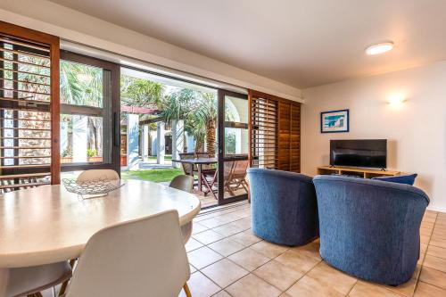 a dining room with a table and chairs at Onetangi Beach Apartments in Onetangi