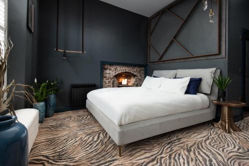 a bedroom with a large bed and a fireplace at The Balcony Luxury Apartment in Berwick-Upon-Tweed