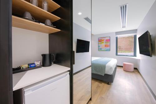 a small room with a bed and a small bedroom at Haberfield Hotel in Sydney
