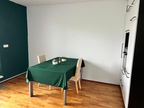 a table with a green table cloth on it in a room at Mattioliho Apartment in Prague