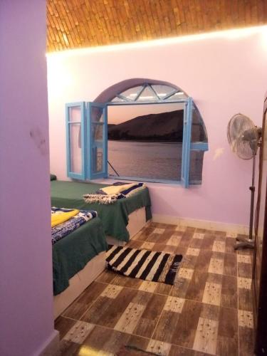 Ein Bett oder Betten in einem Zimmer der Unterkunft hooly nubian