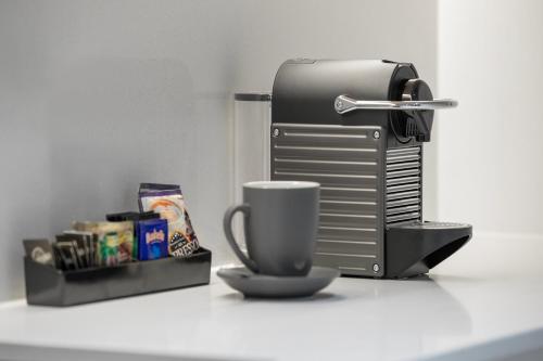 a coffee maker and a cup on a counter at Haberfield Hotel in Sydney