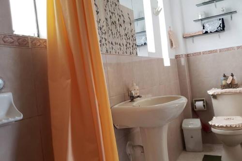 a bathroom with a sink and a toilet and a shower at SAN PAOLY. in Trujillo