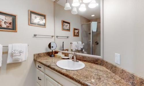 a bathroom with a sink and a mirror at Ho'omaha - Serene Kihei Condo in Maui Kamaole for Ocean Views and Relaxation in Wailea