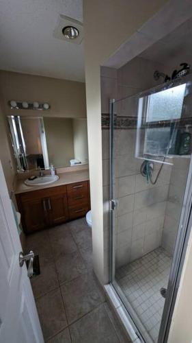 a bathroom with a shower and a sink at Spacious West Kelowna Home that is great for family, friends, or business trip! in West Kelowna