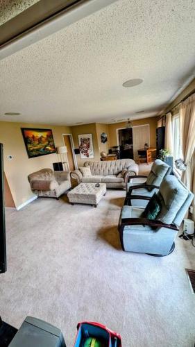 a living room with couches and chairs in a room at Spacious West Kelowna Home that is great for family, friends, or business trip! in West Kelowna