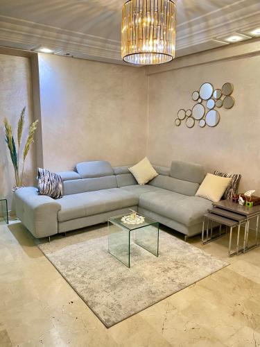 a living room with a couch and a table at Appartement de lux in Casablanca