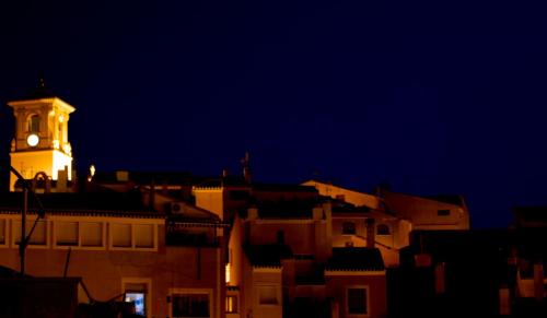 a clock tower on top of a building at night at Olmitos 3, Casa-Palacio Real Piedad in Cehegín