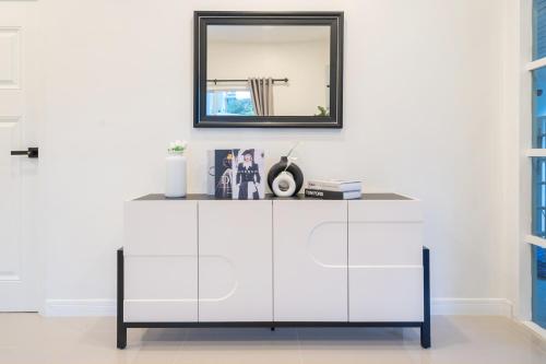 a white cabinet in a room with a mirror at Seven Heaven Patong Villa in Patong Beach