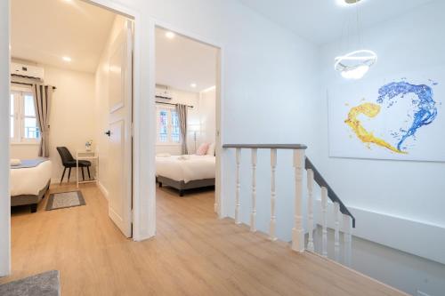 a room with a staircase leading to a bedroom at Seven Heaven Patong Villa in Patong Beach