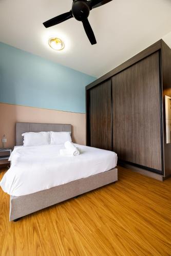 a bedroom with a large bed and a ceiling fan at #12Georgetown Luxury Suite with Rooftop Pool in George Town