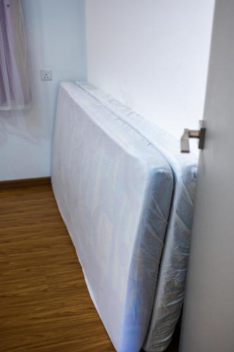 a bed in a room next to a door at #12Georgetown Luxury Suite with Rooftop Pool in George Town