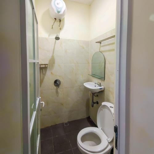 a small bathroom with a toilet and a sink at Balmoral House Ambarukmo in Yogyakarta