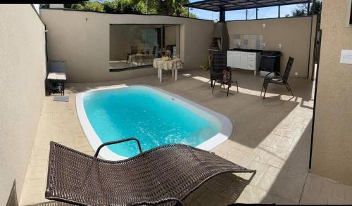 une piscine dans une cour arrière avec une table et des chaises dans l'établissement Casa El Badan Olímpia Thermas dos Laranjais Roma, à Olímpia